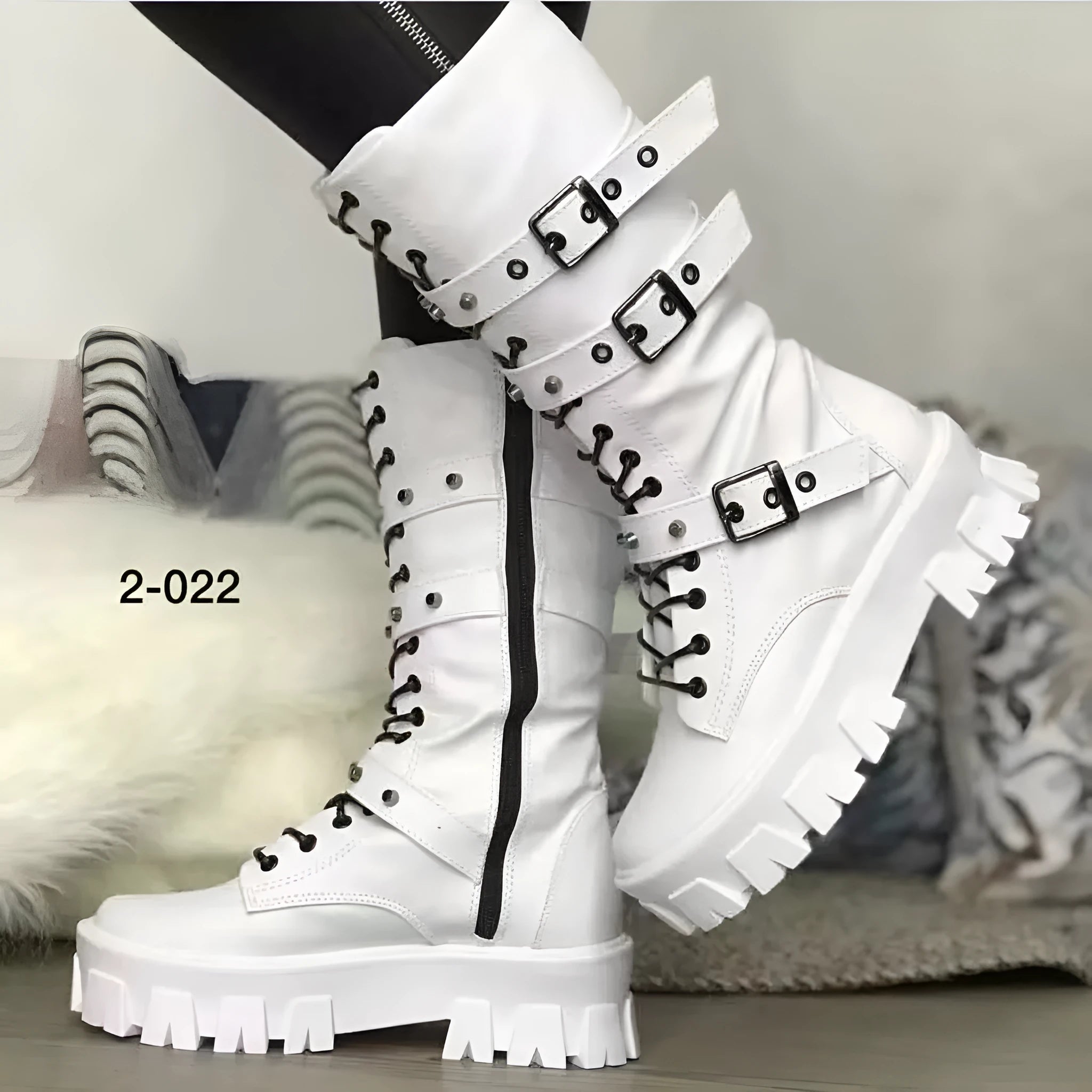 Black women's mid-calf boots with metal buckle detail and a side zip fastening.