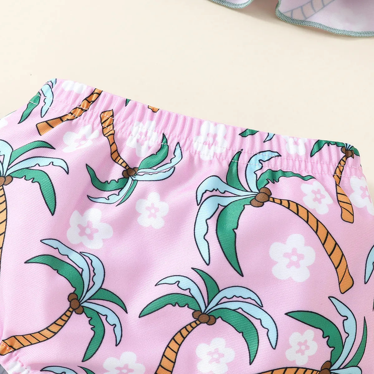 White children's two-piece swimsuit set with a top and matching shorts on a hanger.