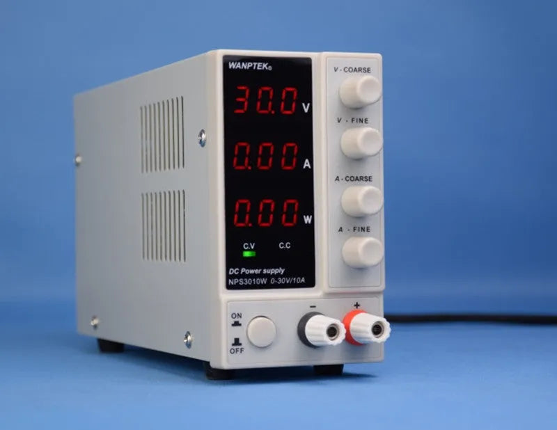 White adjustable DC bench power supply model NPS605W with voltage and current control dials.