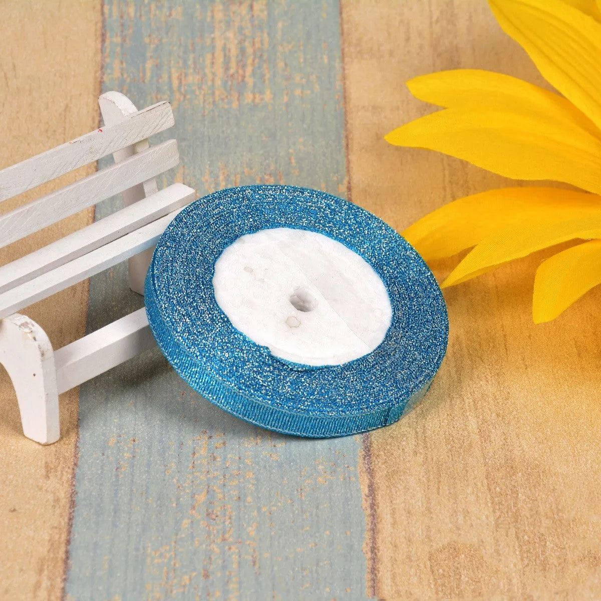 Polyester ribbon spool in metallic colours for decorative clothing and gift packaging trim