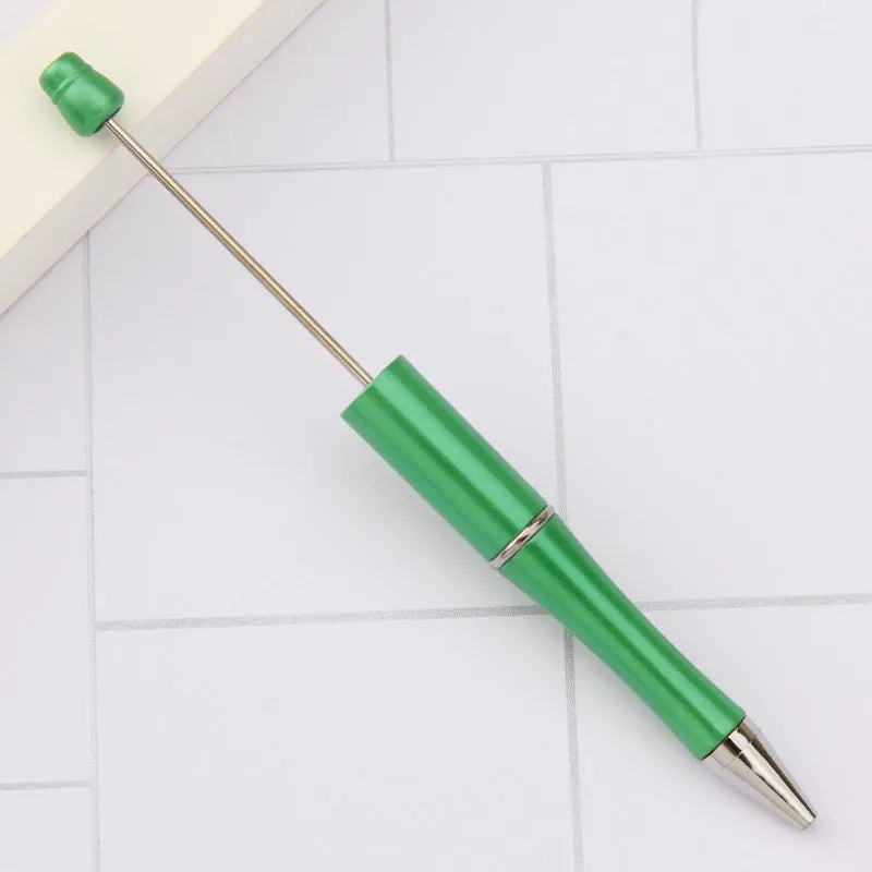 Creative ballpoint pen with multicoloured spinning plastic beads on a steel wire frame.