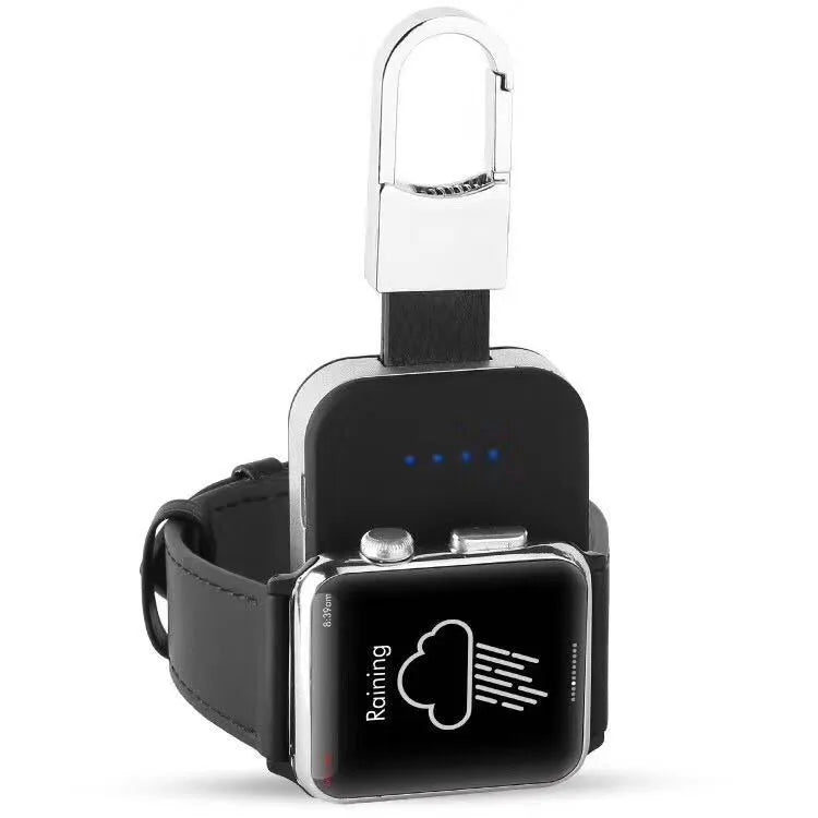 Black Apple Watch portable power bank keychain charger with USB port shown next to an Apple Watch.