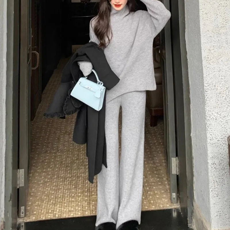 Women's solid colour sweater and wide leg trousers two-piece set in beige, shown as a coordinated outfit.