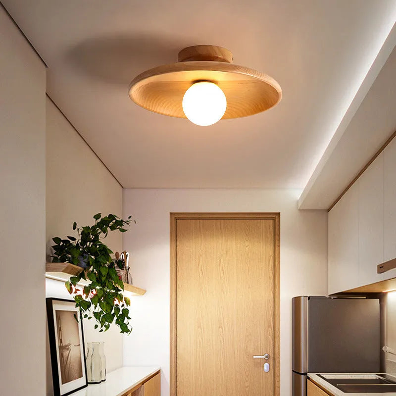 Minimalist solid wood and glass ceiling lamp in natural wood finish, 28cm diameter.