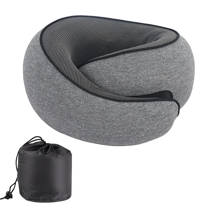 U-shaped memory foam travel neck pillow in a storage bag, shown in dark grey colour.