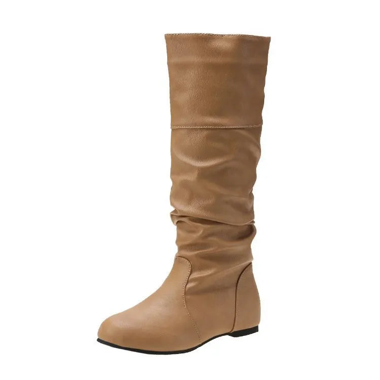 Women's black slip-on flat boots with round toe and high cylinder design on a neutral background.