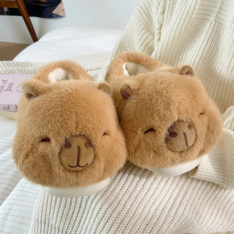 Light brown women's plush winter slippers with cartoon pattern and artificial wool lining.