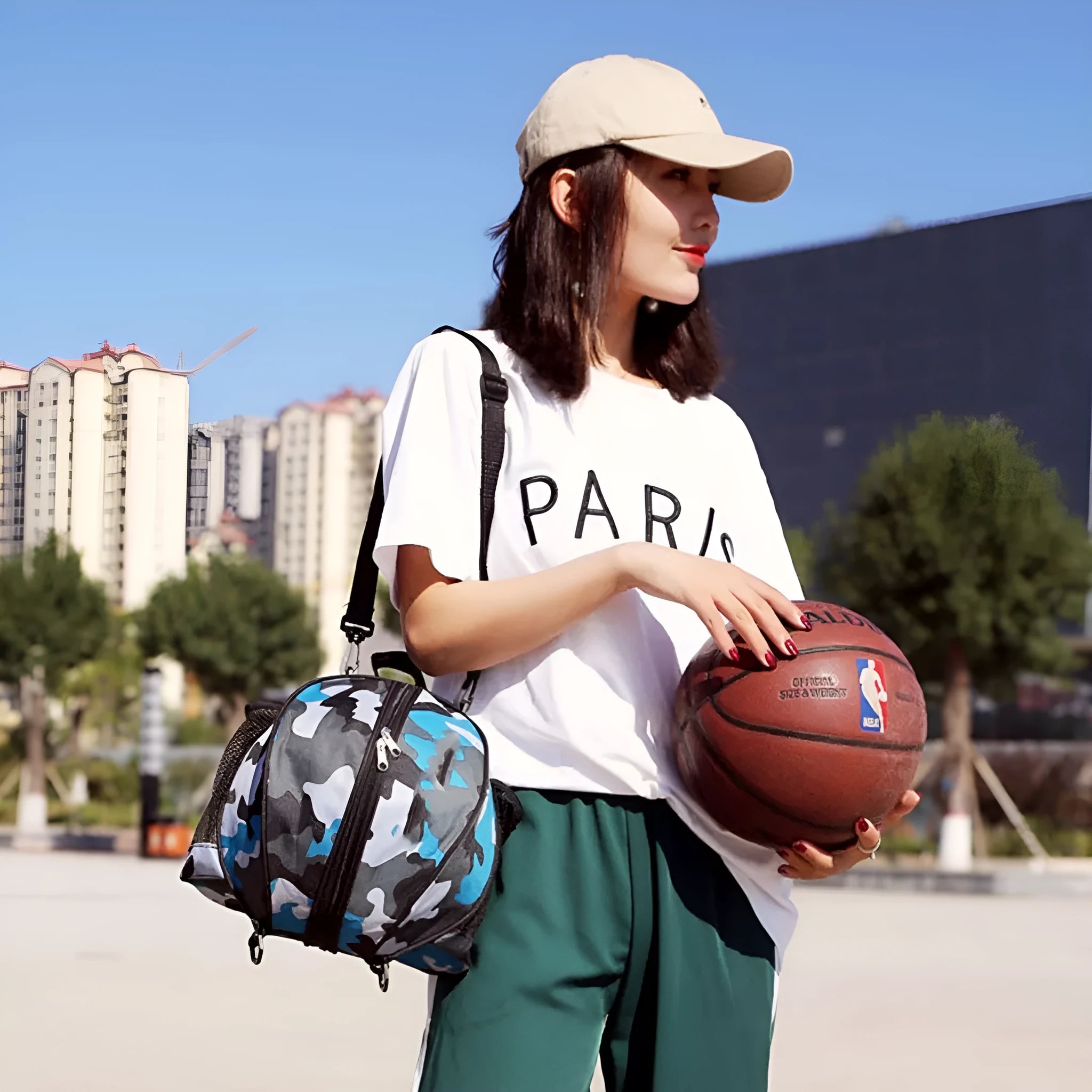 Black Oxford cloth basketball bag with a 9-litre capacity shown with both one-shoulder and two-shoulder strap options.