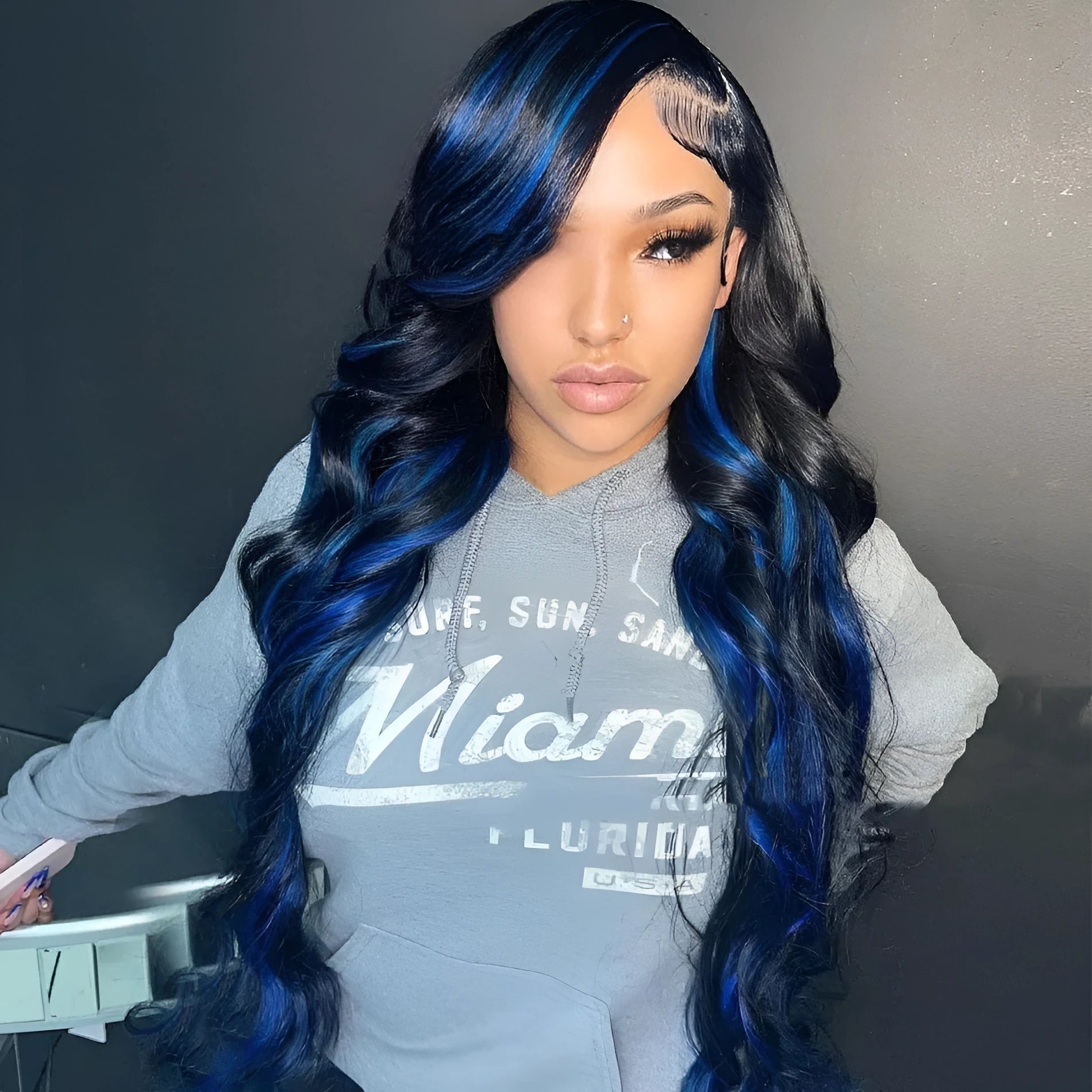 A woman wearing a long real human hair wig with a visible 4x4 lace front hairline.