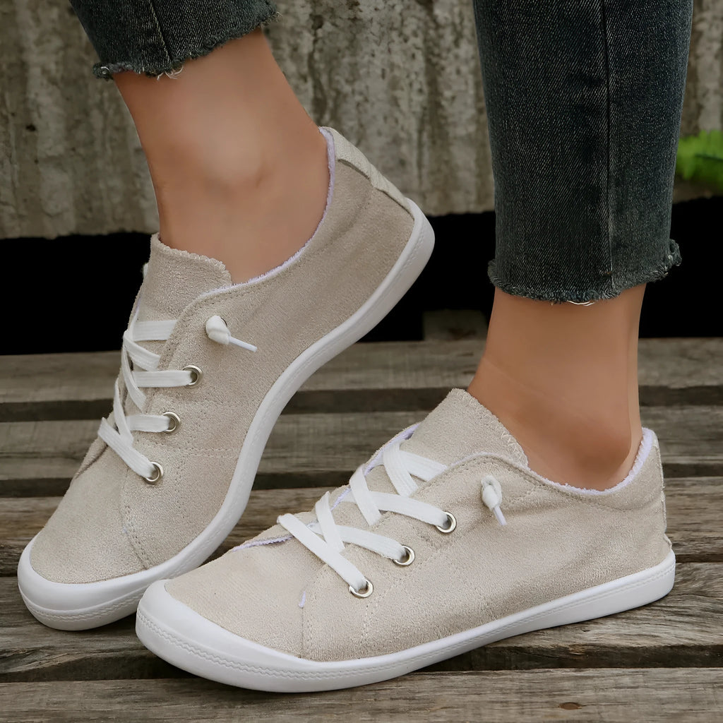 Women's creamy white casual sneakers with fabric upper and rubber sole on multiple surfaces