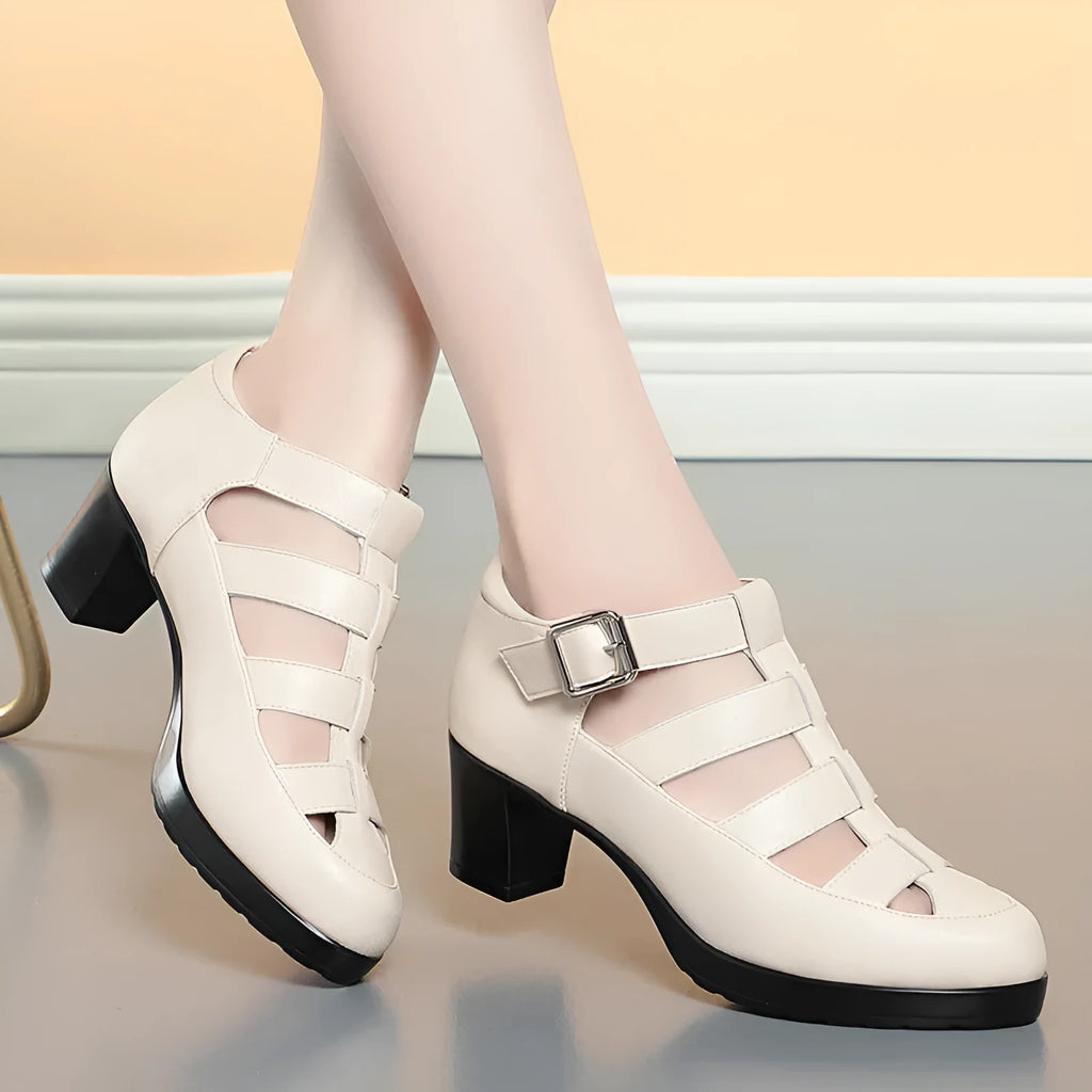 Women's beige closed toe sandals with a chunky heel, woven upper, ankle strap buckle, and back zipper.