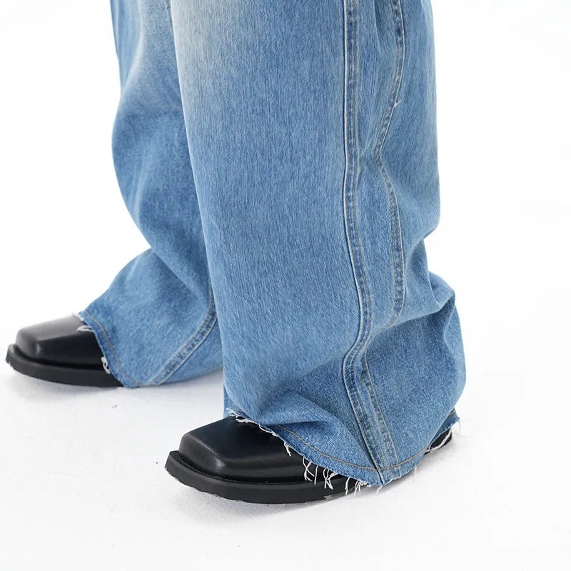 Light blue vintage washed wide leg machete jeans with a straight fit and zipper fly on a model.