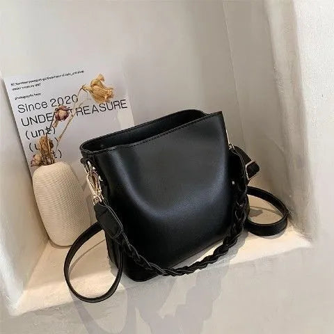 Retro khaki crossbody bucket bag with woven PU detailing and adjustable strap.
