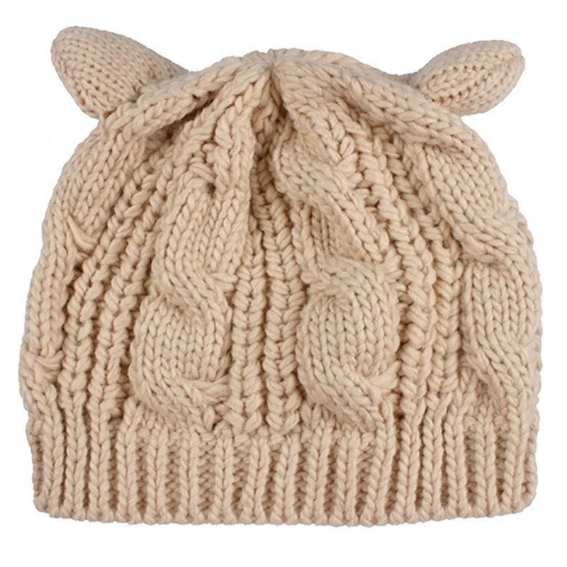 Hand-made chunky wool beanie with 3D knitted cat ears on a white background.