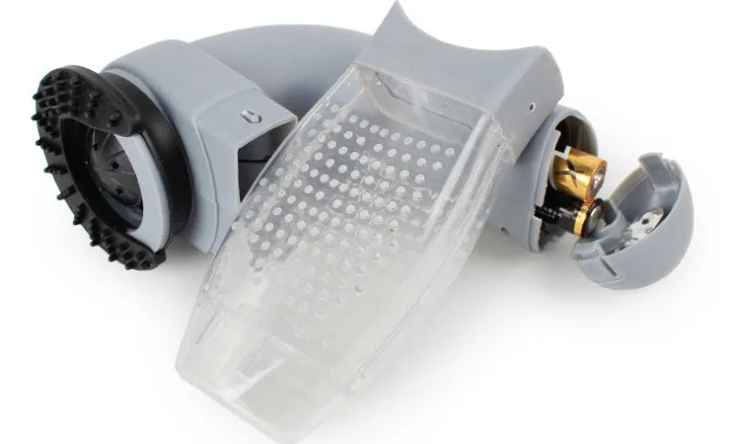 Grey portable pet hair vacuum cleaner with soft rubber head and large collection canister on a fabric sofa.
