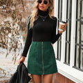 Women's high waist short skirt with stitching detail and zipper in black, shown on model.
