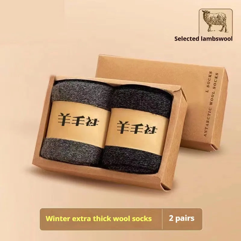 Two pairs of thick grey winter wool socks with a merino midsole next to a storage box
