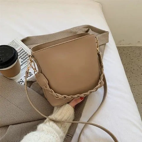 Retro khaki crossbody bucket bag with woven PU detailing and adjustable strap.