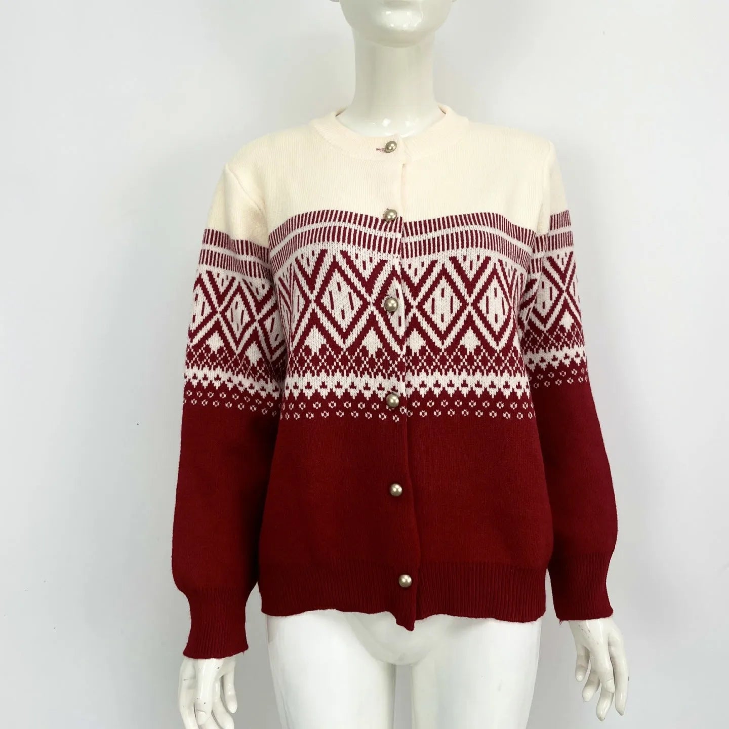 Woman wearing a grey alpaca wool cardigan with a long sleeve diamond pattern in a contrast colour.