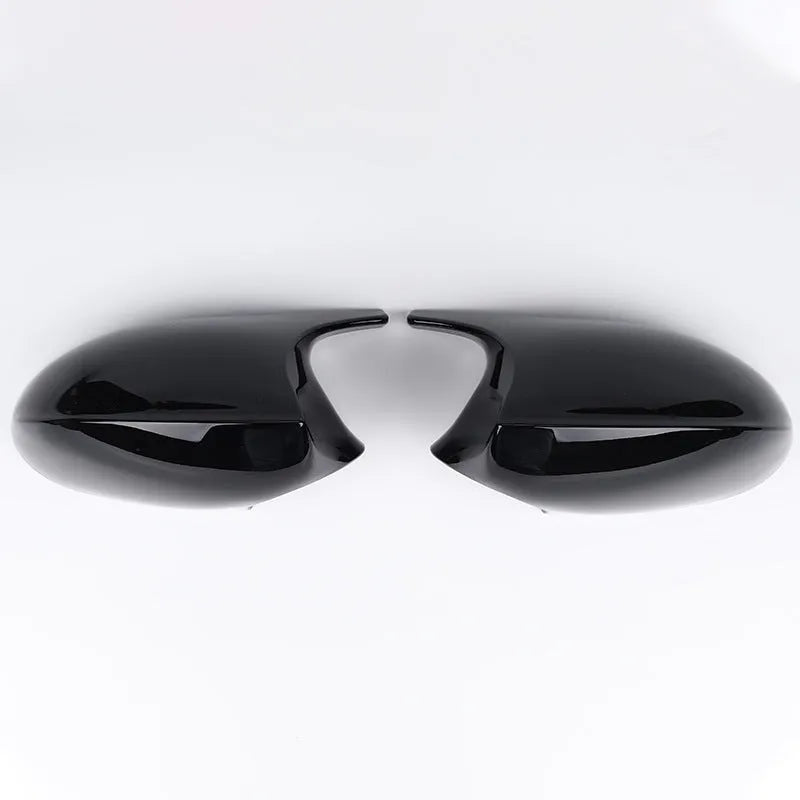 Pair of black ABS plastic rearview mirror housings for BMW 3 Series E90 on a white background.