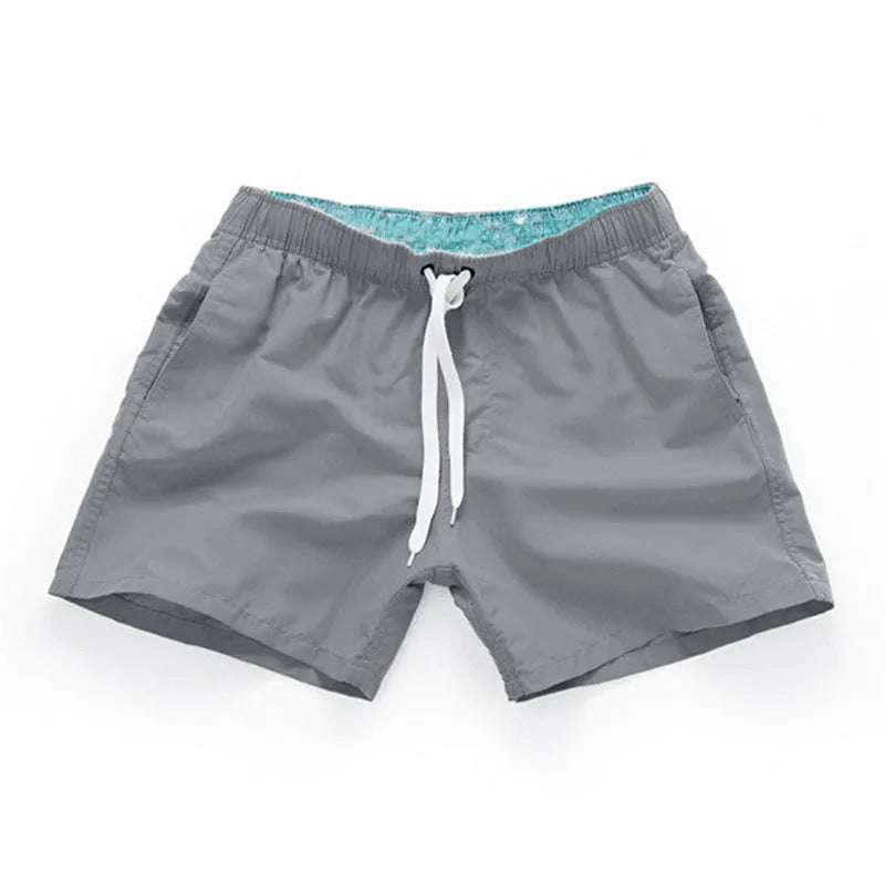 Men's straight leg beach shorts in multiple colours, made from polyester fabric, shown on size chart from S to 4XL.