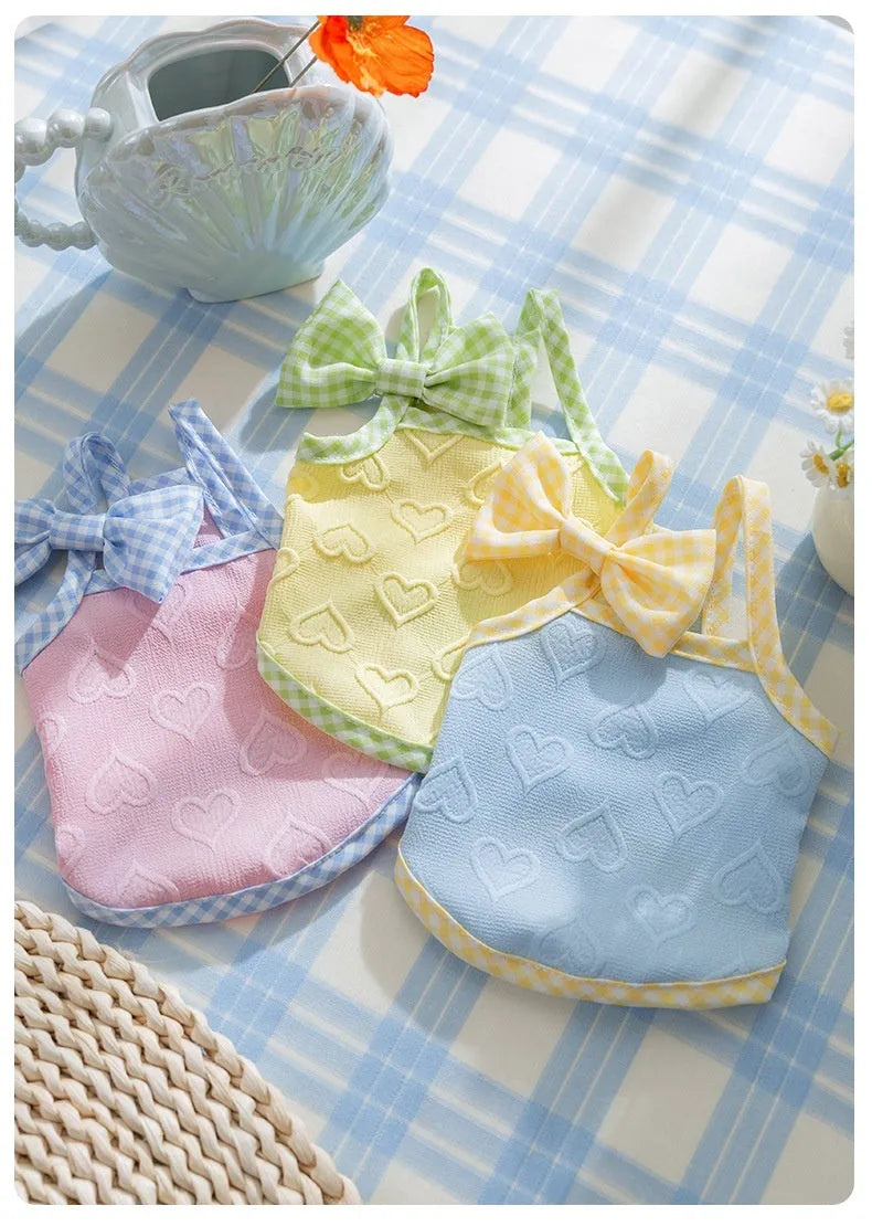 Small dog wearing heart texture elastic vest with bow suspenders in Bondi Blue colour