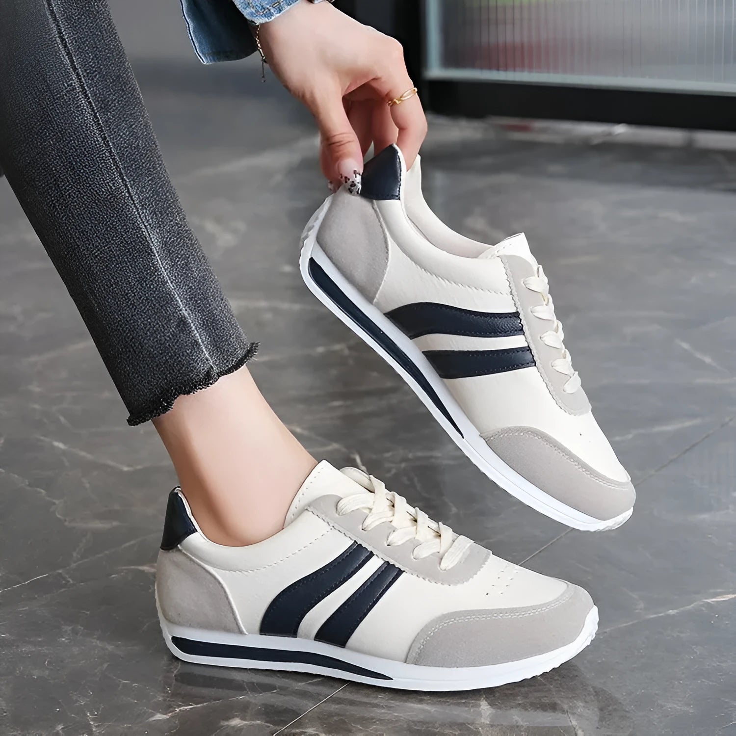 Red and blue low-top lace-up casual sneakers with a round toe and rubber sole.
