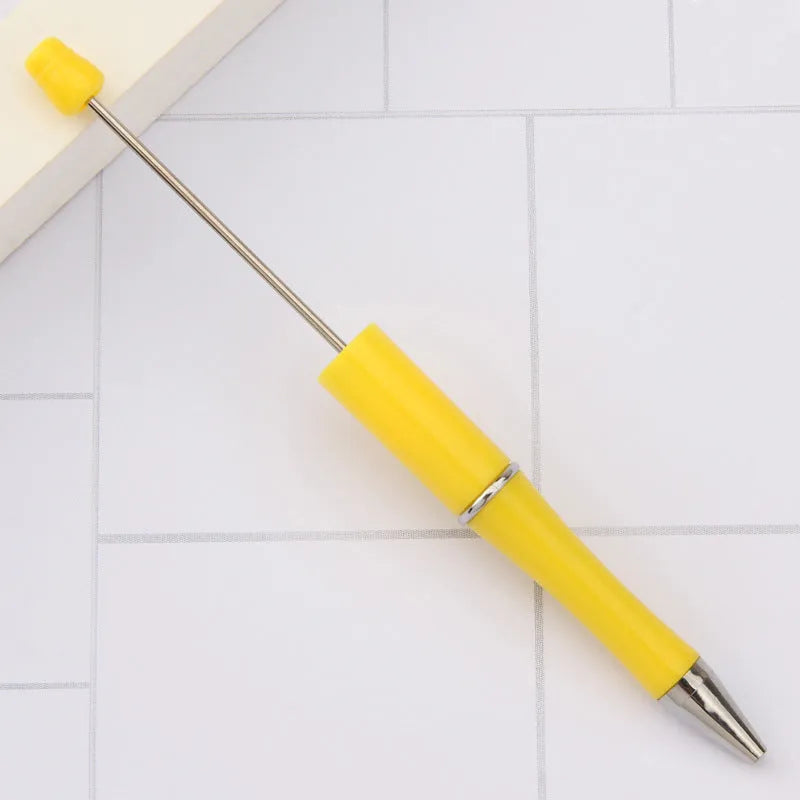 Creative ballpoint pen with multicoloured spinning plastic beads on a steel wire frame.