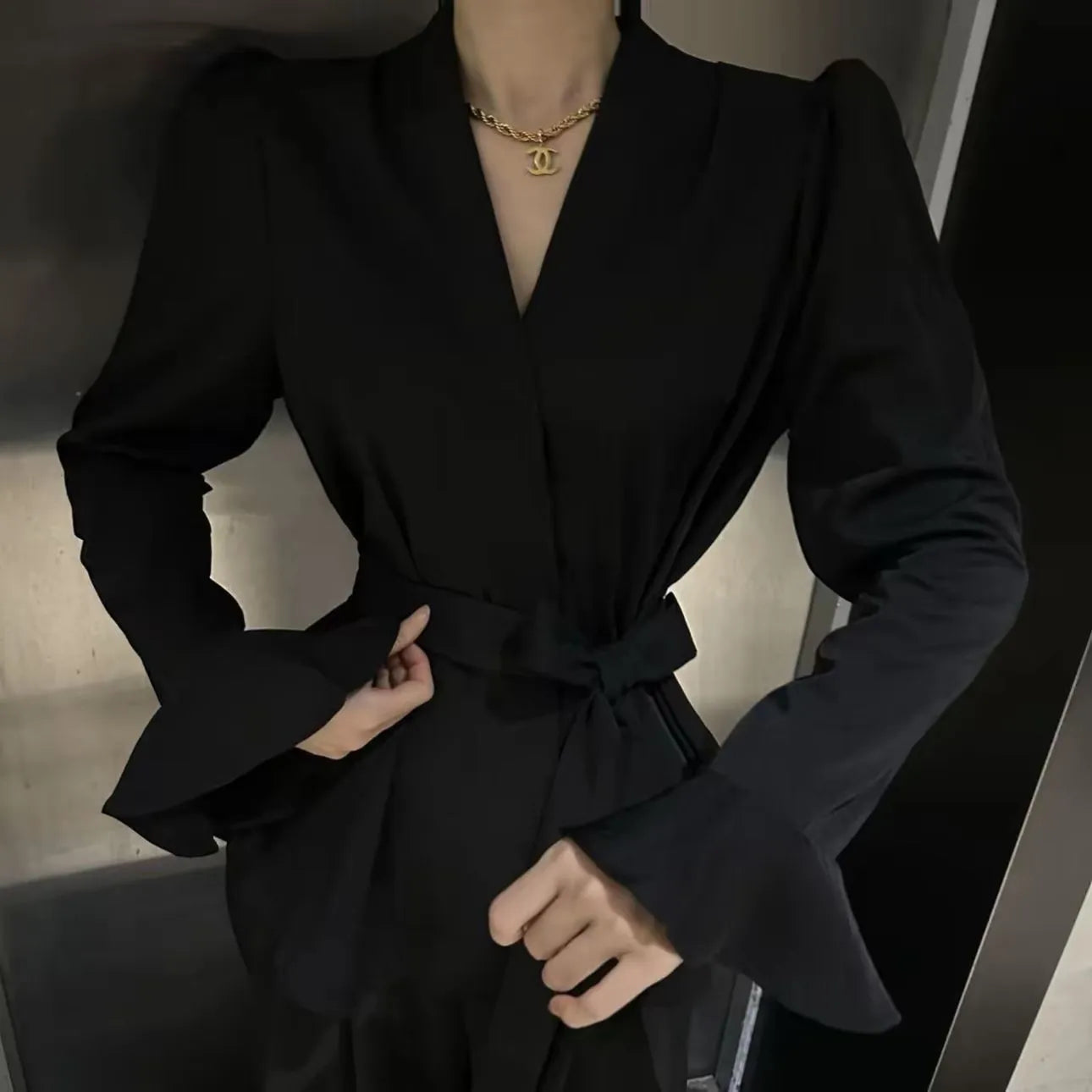 Women's French-style irregular collar long sleeve shirt with bell sleeves and a tie front.