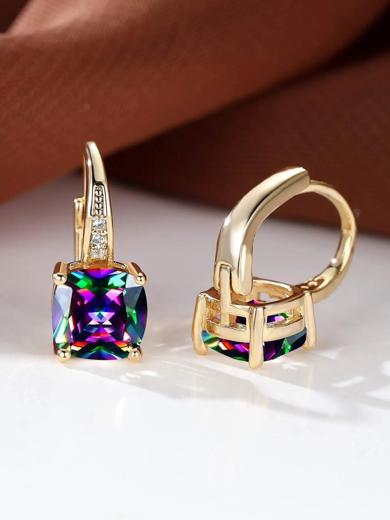 Square geometric ear clips with colourful moissanite stones in gold and silver electroplated finishes.