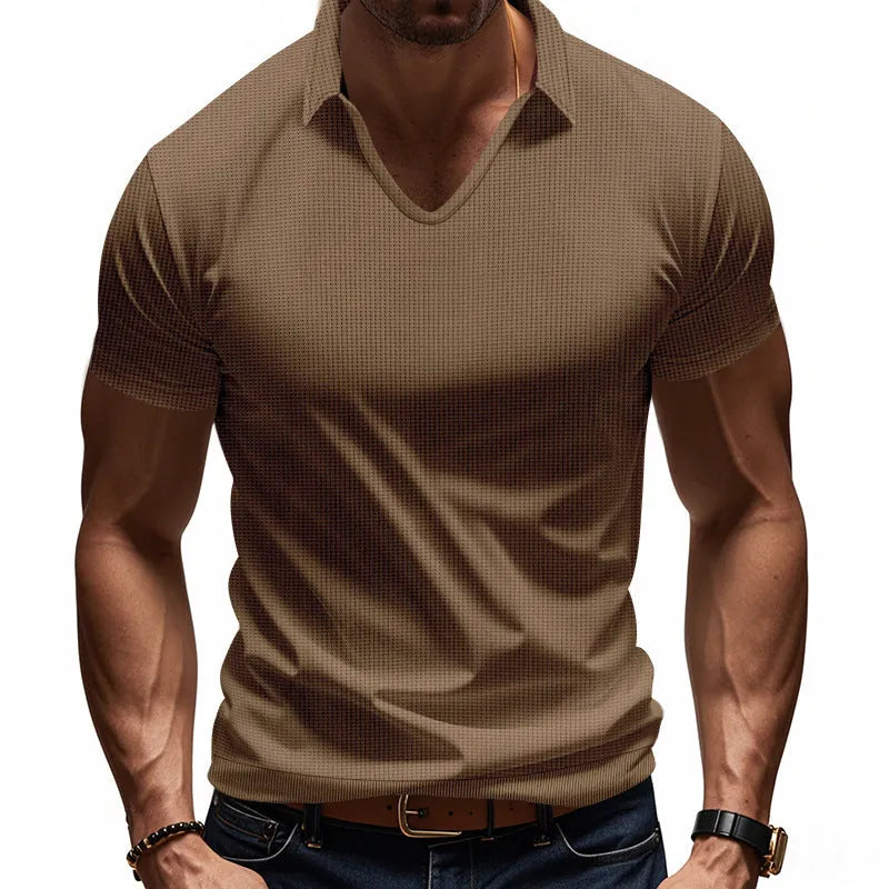 Man wearing a loose-fit apricot coloured V-neck short sleeve cotton blend T-shirt.