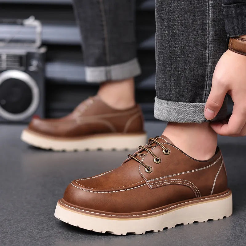 Men's black retro Martin boots with round toe and low-top design on a plain background