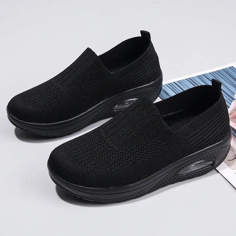 Women's casual running shoes with mesh and PU upper in light gray, showing round toe and mid heel.