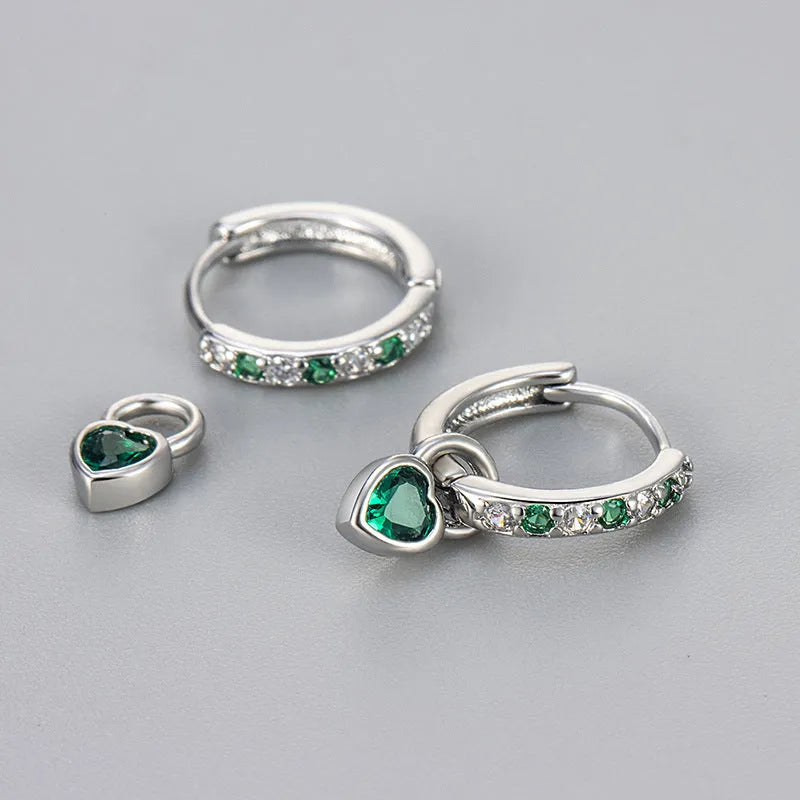 Women's fashion earrings with heart-shaped drops containing coloured gemstones in gold or white gold colour settings
