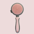 Green and pink 2-in-1 silicone cat brush showing slicker brush side and octopus-teethed massager side