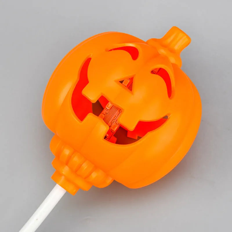 Plastic pumpkin-shaped USB lamp emitting purple or yellow light, 8.3cm wide.