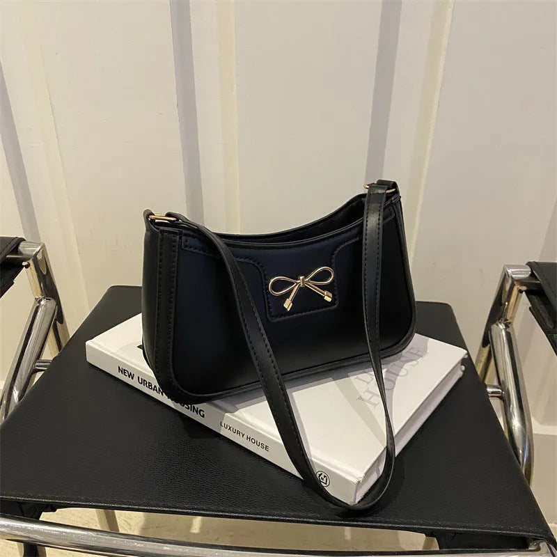Western style PU leather shoulder bag with bow detail in horizontal square shape.