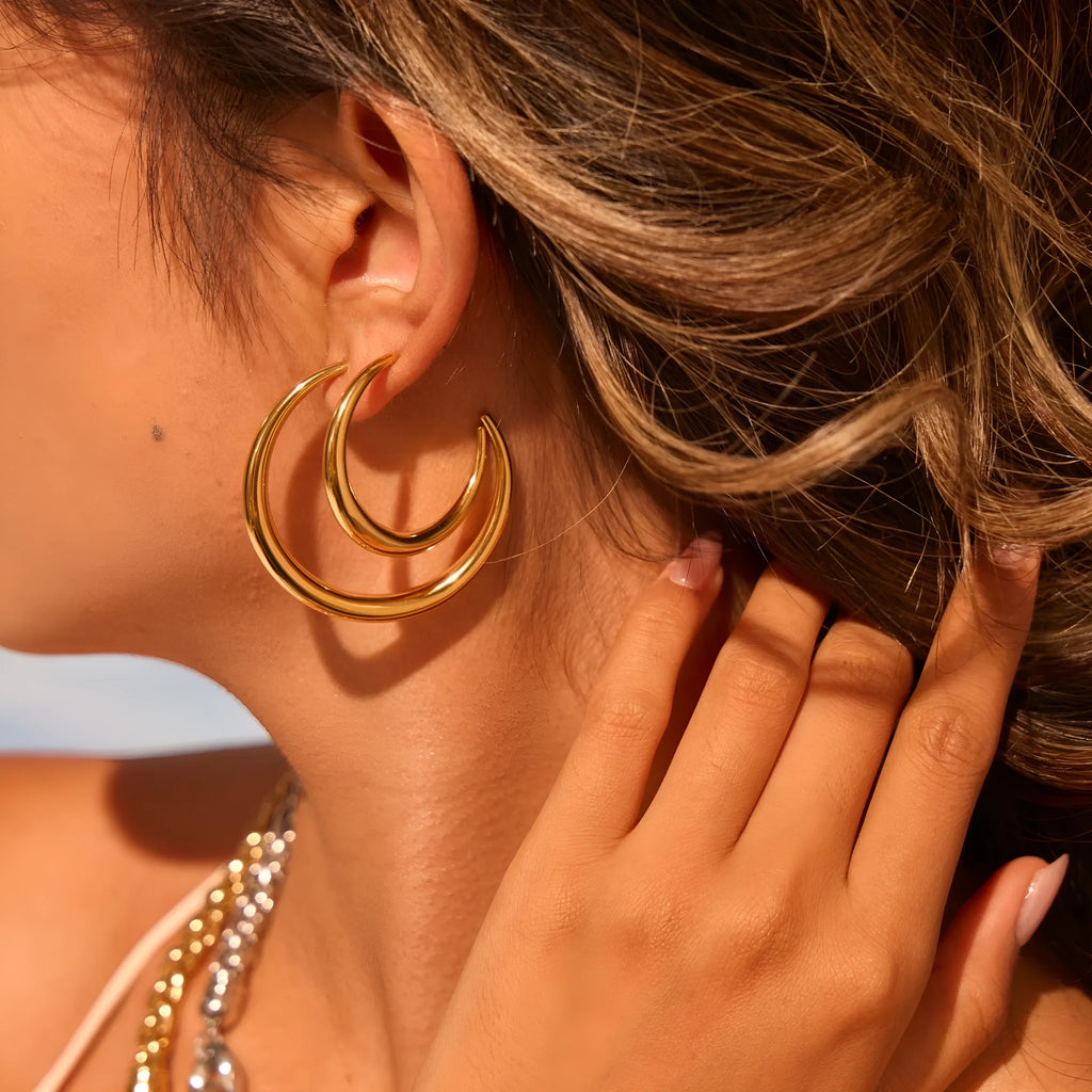 Titanium steel geometric hoop earrings with circular design and gold or steel finishes