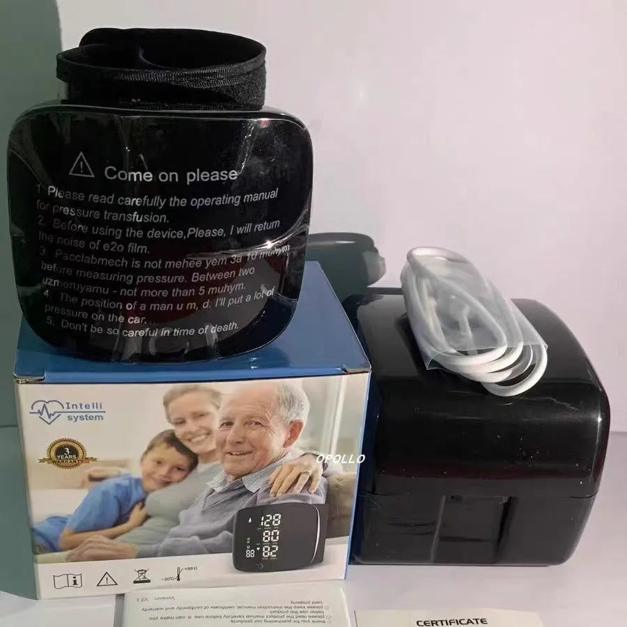 Black wrist blood pressure monitor with digital display, shown with USB charging cable.