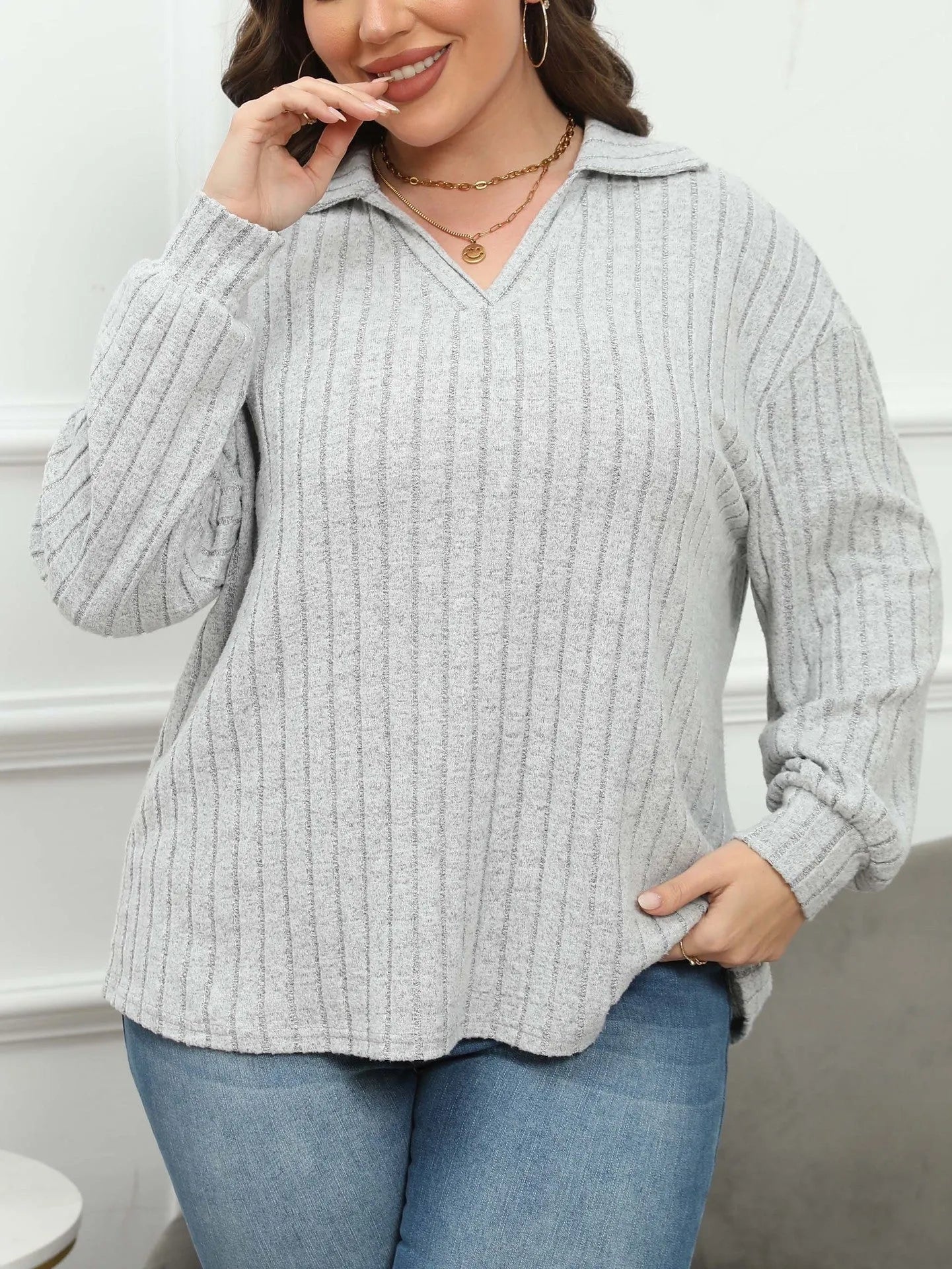 Women's plus size gray polo collar fleece shirt with lantern sleeves on a hanger