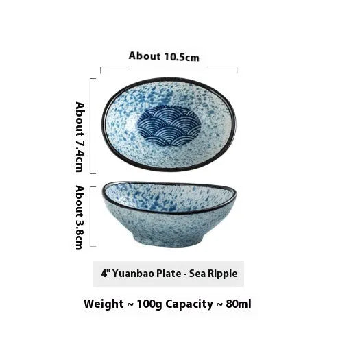Japanese ceramic oval sauce dipping bowl with traditional underglaze pattern on white background