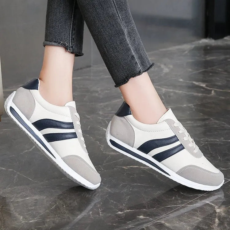 Red and blue low-top lace-up casual sneakers with a round toe and rubber sole.