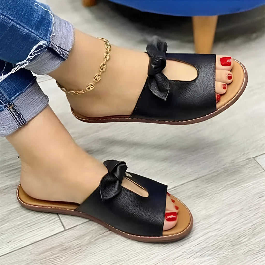 Ladies casual sandals with bow decoration and fish mouth toe opening in black, pink, and gold colours.