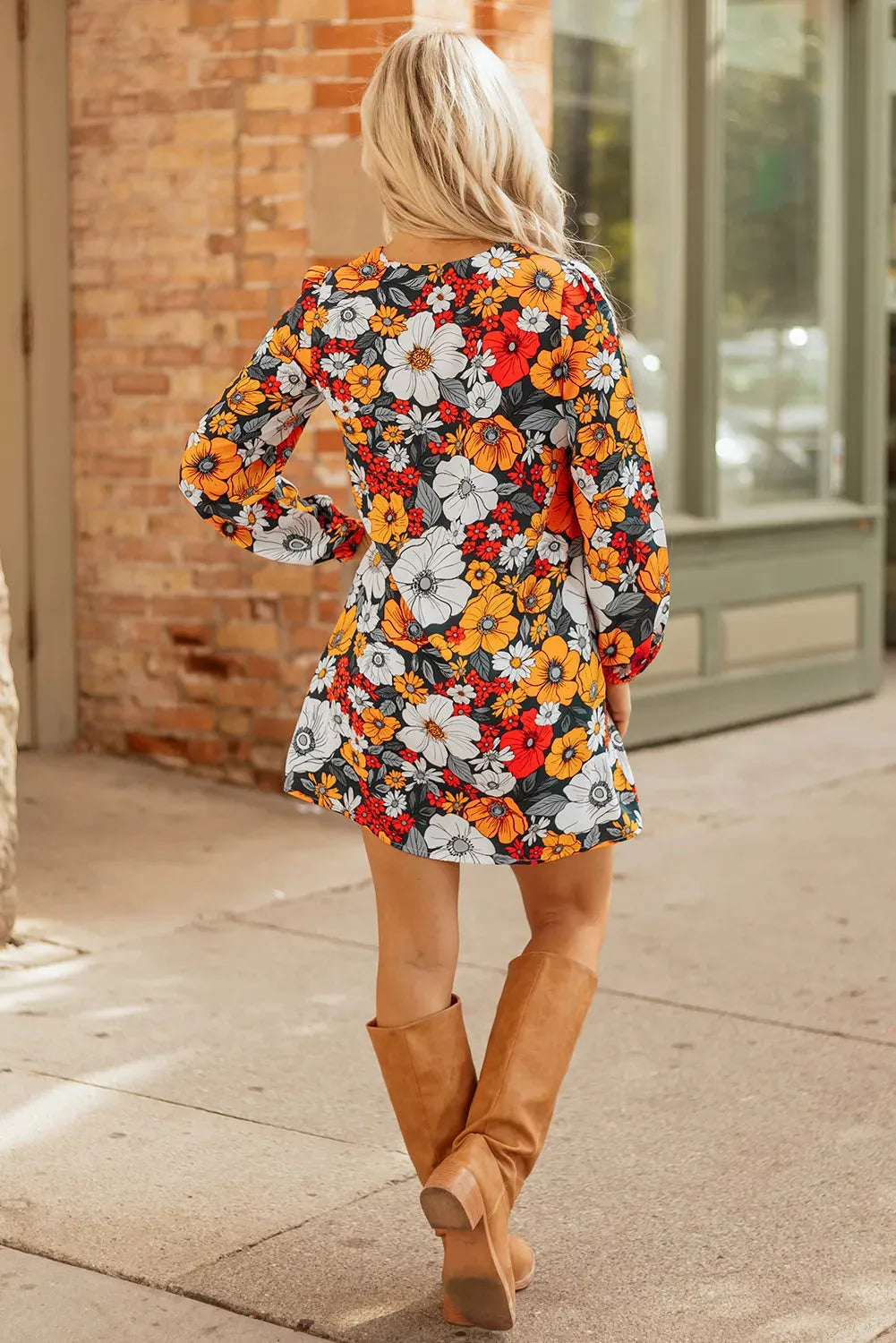 Orange women's mini dress with floral striped print and lace detailing, featuring a V neck and long sleeves.