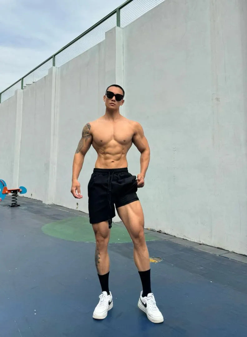 Men's ice silk quick-drying double-layer shorts in light grey, showing casual fit and elastic waistband.