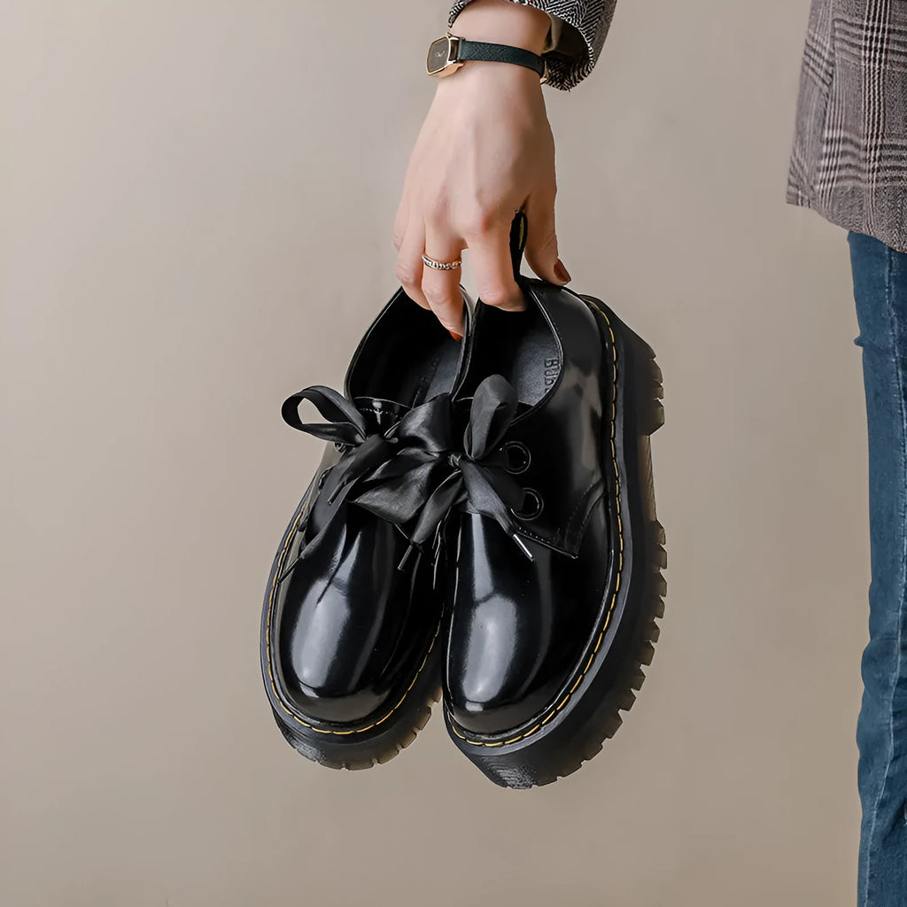 Women's white thick-soled lace-up shoes with ribbon and cross-strap details on a superfine fibre upper.