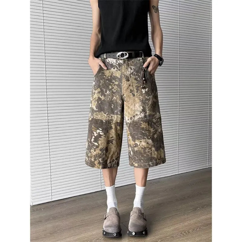 Yellow women's cropped jeans with a large snake camouflage pattern tooling print on the denim fabric.