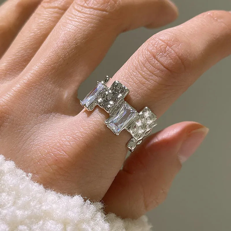 Silver geometric zircon cross ring with open centre and retro design