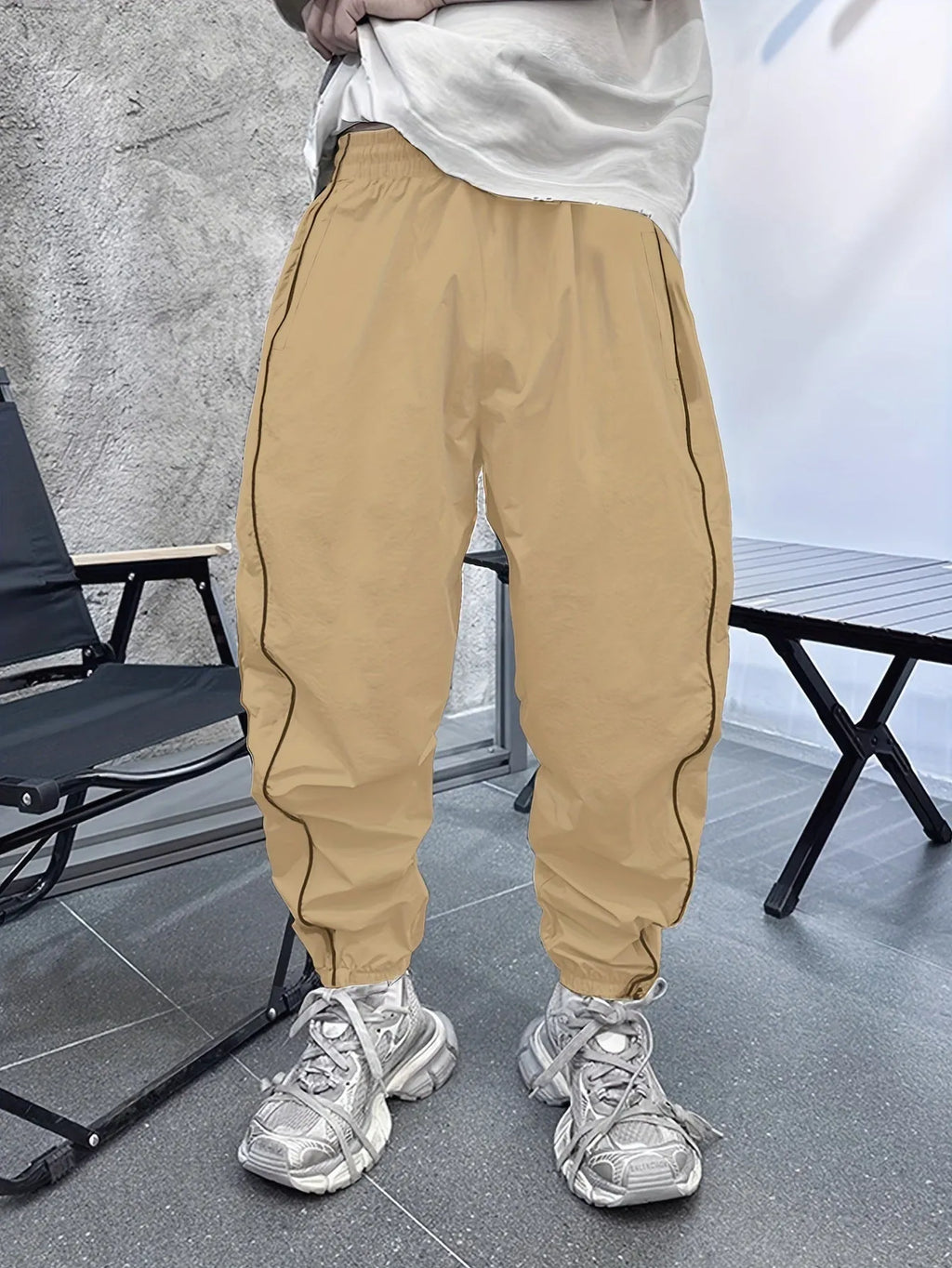 Man wearing blue bamboo fibre casual trousers with a cropped leg and loose fit.