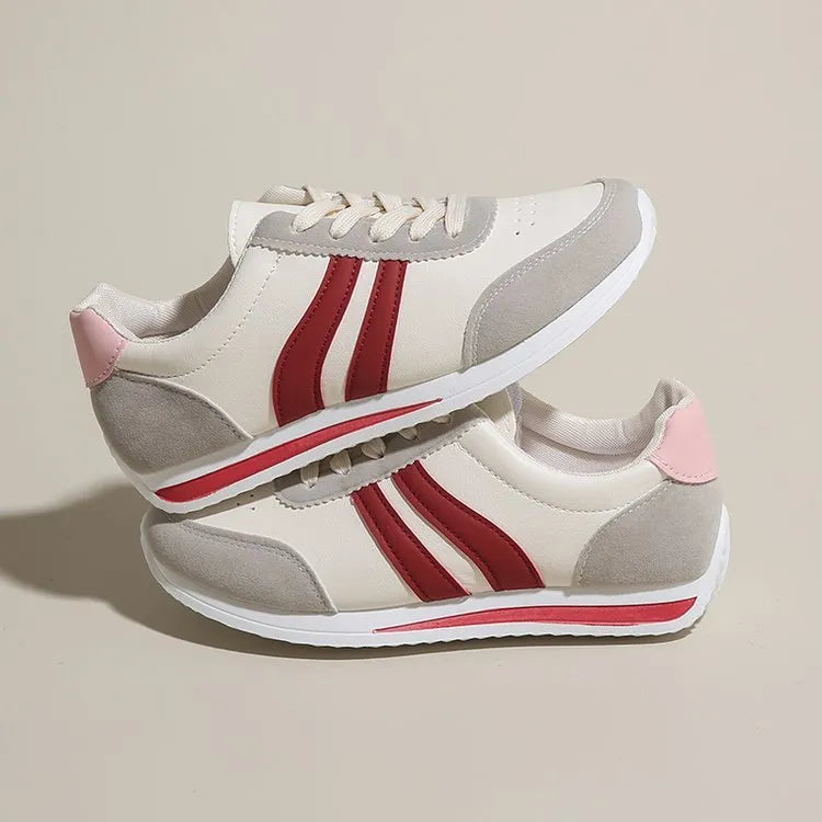 Red and blue low-top lace-up casual sneakers with a round toe and rubber sole.